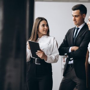 Male and female business people working on tablet in office